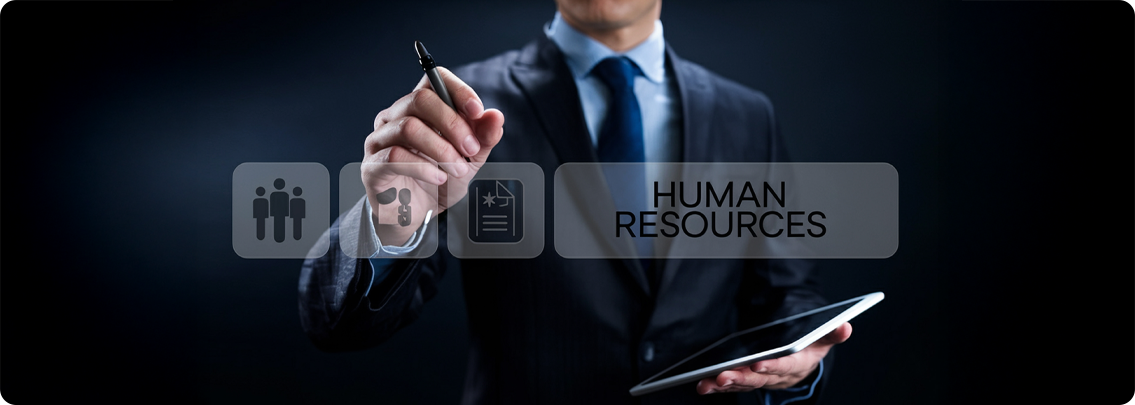 HR staff transferring information from paper documents to a computer system, representing manual HR processes.